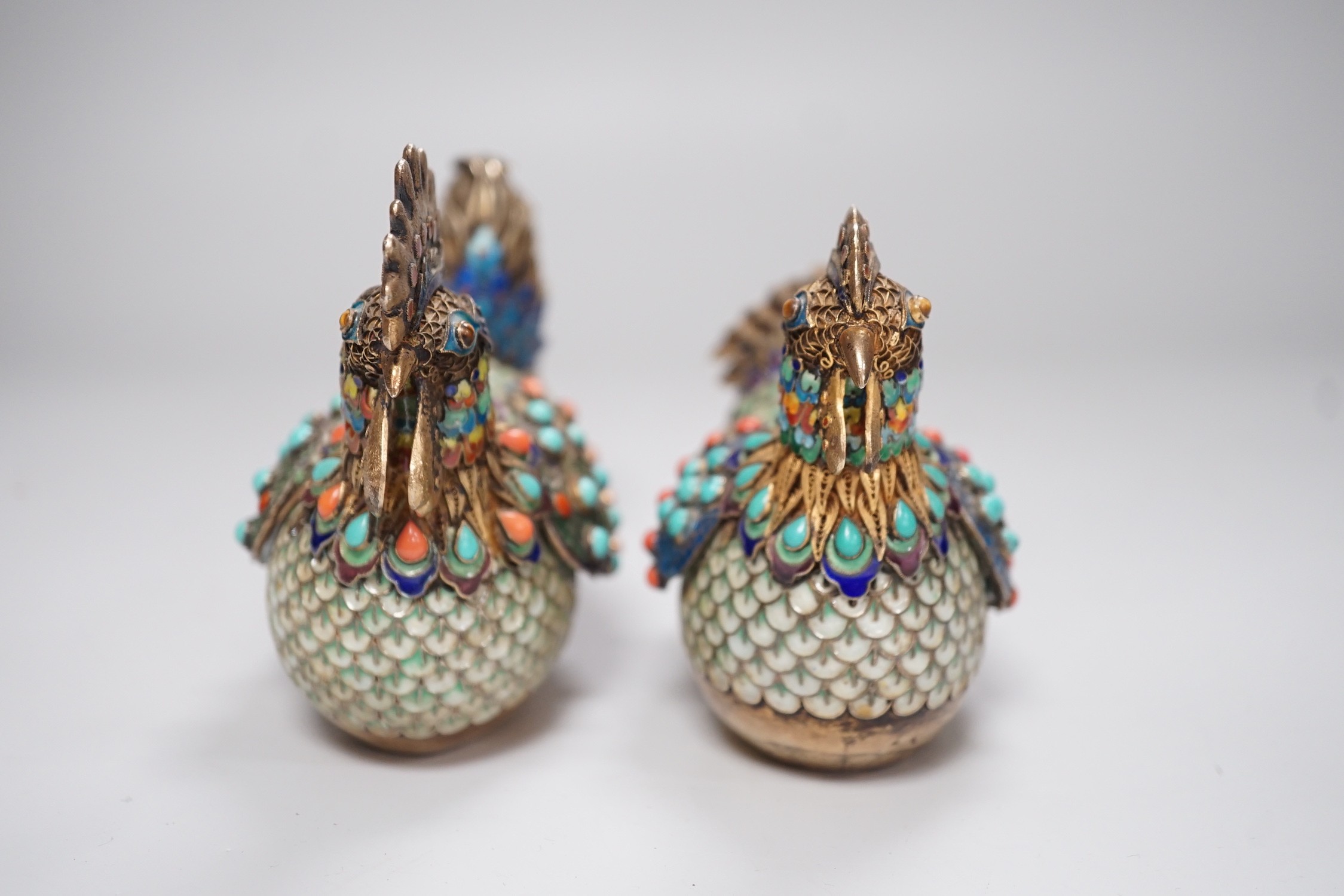 A pair of cased Chinese enamelled gilt white metal roosters with turquoise and coral mounts 14cms wide